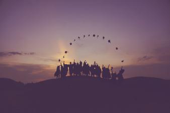students throwing graduation hats