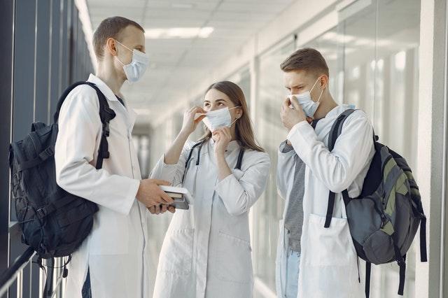 group of medical students in the hallway wearing face masks